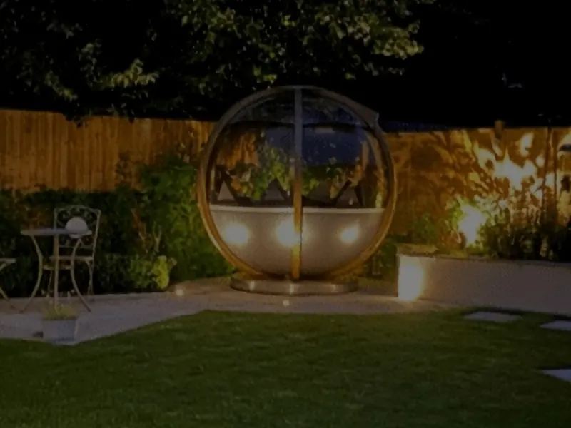 Garden lighting illuminating a lawn and seating pod after dark